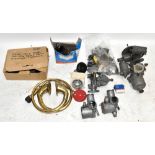 A selection of various classic car parts, including SU carburettors, Zenith carburettor, 12v fuel