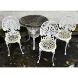 A Victorian white painted iron framed Britannia table with wooden top, and three aluminium chairs (