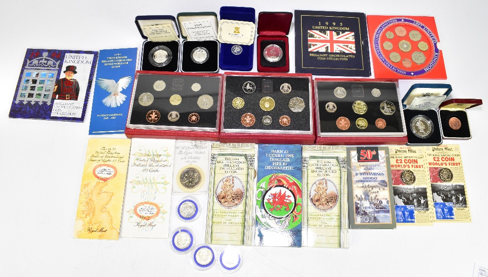 An assortment of British coinage, including Royal Mint proof sets, silver proof crown produced to