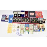 An assortment of British coinage, including Royal Mint proof sets, silver proof crown produced to