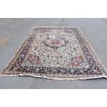 A Persian wool carpet, worked with a central medallion and allover floral design against an ivory