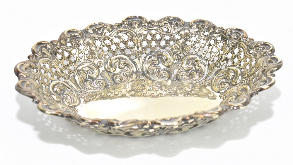 HORACE WOODWARD & CO LTD; a Victorian hallmarked silver oval bonbon dish with cast scrolling rim and