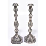 MAURICE SALKIND (PROBABLY); a pair of George V hallmarked silver candlesticks with repoussé floral