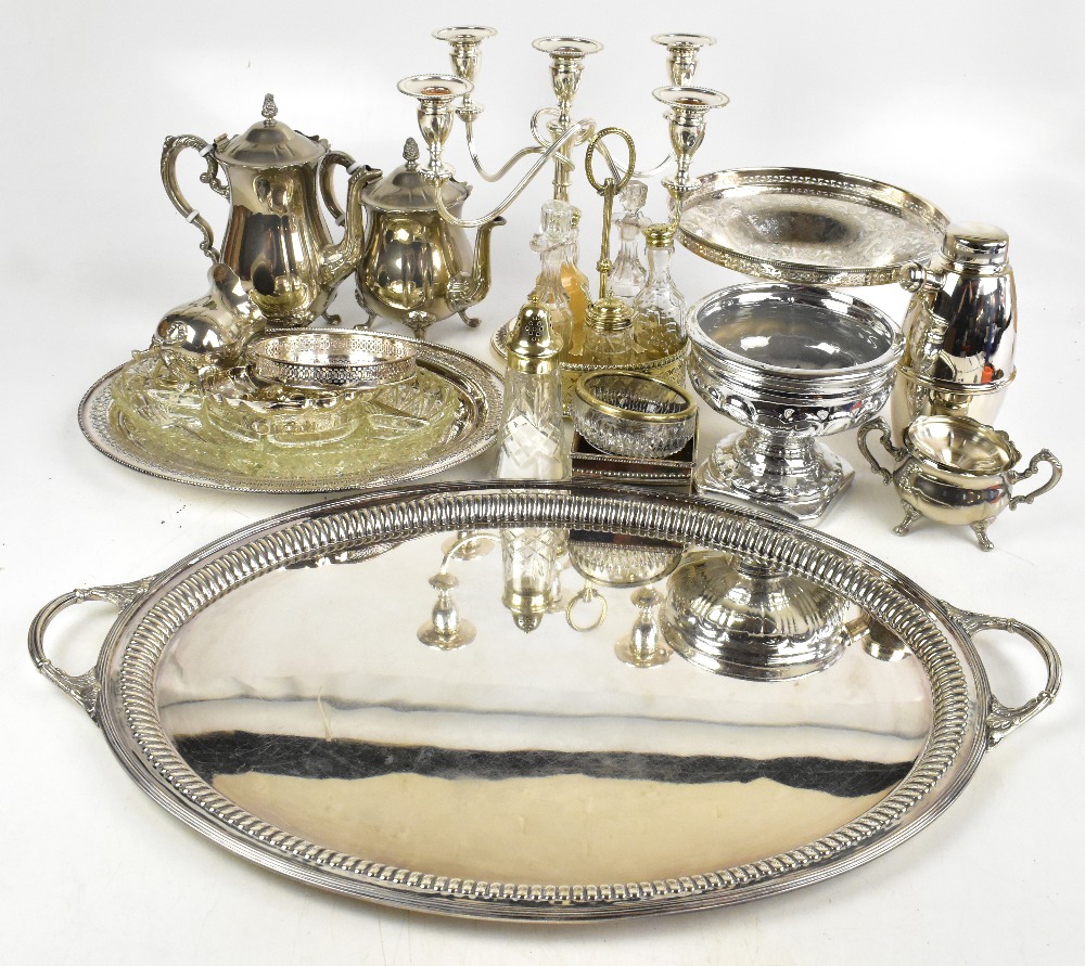 A collection of electroplated items including a candelabrum, a large twin handled tray, a cocktail