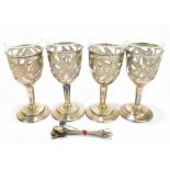 Three Mexican sterling silver mounted wine glasses with pierced floral decoration and clear glass