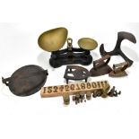 A set of iron framed balance scales, a wrought iron boot stretcher, and assorted metalware.