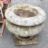 A stone garden urn, on square base, height 32cm.
