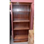 A modern mahogany freestanding bookcase, with moulded cornice above an arrangement of adjustable