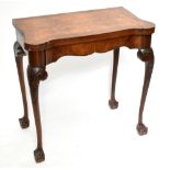 A reproduction walnut serpentine fronted fold over swivel-top card table with baize material to