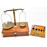 An early 20th century set of balance scales with associated weights.