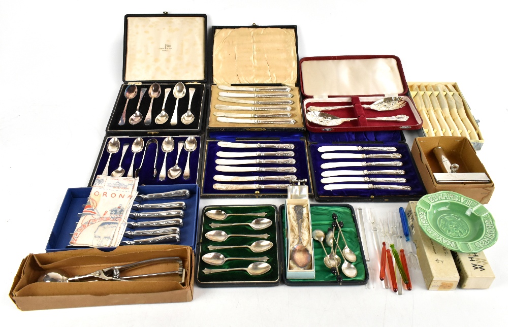 An assortment of silver plated flatware and steel bladed flatware, with an assortment of vintage
