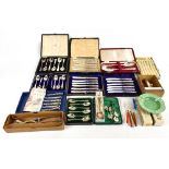 An assortment of silver plated flatware and steel bladed flatware, with an assortment of vintage