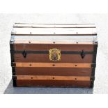 A vintage wooden bound canvas dome top travelling trunk.