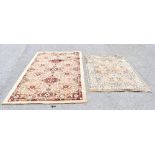 Two machine woven rugs, each decorated with an allover floral design, the largest 222 x 137cm.