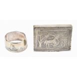 An Indian white metal snuff box of rectangular form, embossed and chased with giraffes in landscape,