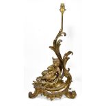 A late 19th century cherubic gilt metal scrolling table lamp, height including fitment 65cm.