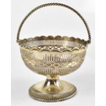 A Victorian hallmarked silver circular pierced basket with twist handle, indistinct marks to the