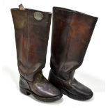 A pair of German military brown leather hobnail boots, both applied with an oval numbered plaque,