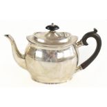 HAMILTON & INCHES; a Scottish hallmarked silver oval teapot, with ebony finial and handle, Edinburgh