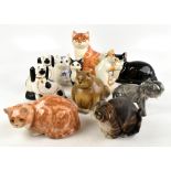 A collection of nine modern large ceramic models of cats, including a Philip Laureston model of a