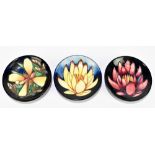 MOORCROFT; three circular pin dishes including two examples decorated by Emma Bossons for the