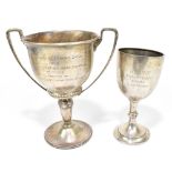 GOLDSMITHS & SILVERSMITHS CO; a George V hallmarked silver twin handled trophy cup with presentation