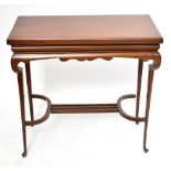 An Edwardian mahogany fold over swivel-top card table on turned column supports, width 83cm, depth