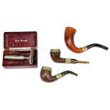 An early 20th century cased pipe with horn mouthpiece and silver plated mount, also two pipes, one