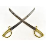 A pair of late 19th century brass handled curved swords, with ribbed detail to the grip, length