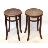 A pair of early 20th century bentwood stools on swept column supports (2).