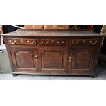 An 18th century oak sideboard with galleried back panel over three drawers above two panelled doors,