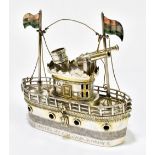 A novelty Indian white metal model of a steam vessel with Indian flags, twin cannon and