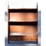 A reproduction mahogany hanging waterfall shelf, with two base drawers, height 76cm, width 51cm,