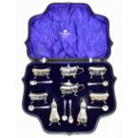 A cased George V hallmarked silver eight piece cruet, comprising a pair of peppers, two pairs of