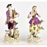 MEISSEN; a pair of 19th century ceramic figures of a male and female musician, he with a dog and a