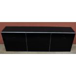 EMMEBI DESIGN; a modern black and metal three section wall unit, height 60cm, length 179cm.