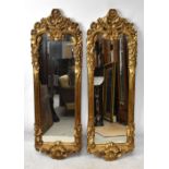 A pair of modern gilt framed shaped rectangular wall mirrors in the Rococo style, height 130cm,