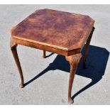 A 1950s burr walnut veneered games table of square form, with rotating top enclosing baize