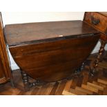 An 18th century oak drop-leaf gateleg dining table on bobbin turned supports, width 103cm, height