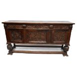 A large reproduction carved oak sideboard in the Flemish style with three drawers above three