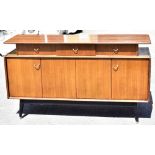 G-PLAN; a mid-century mahogany and ebonised sideboard with three above an arrangement of four