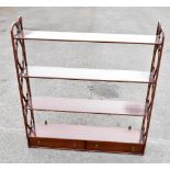 A reproduction mahogany hanging shelf with four fixed shelves above two drawers, with open work