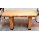 An Art Deco bird's eye maple and walnut centre table, the shaped rectangular top on two plinth