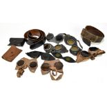 A group of German military goggles, two belts, and two pouches.