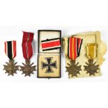 A collection of five WWII German Third Reich medals, comprising a boxed 1939 white metal Iron Cross,