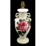 IN THE MANNER OF WEMYSS; a cream glazed rose painted twin handled table lamp, unmarked, height