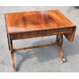 A reproduction mahogany drop-leaf sofa table, on lyre supports terminating on brass castors, width