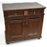 An 18th century oak sideboard with carved and moulded detail above a single drawer and two