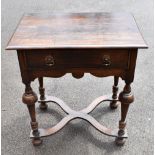 An 18th century oak side table with single drawer on shaped X-stretcher, terminating on bun feet.