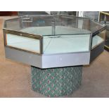 A contemporary aluminium octagonal display case, with four lockable doors, on carpeted octagonal